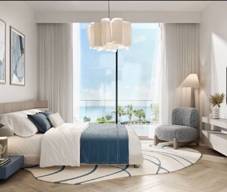 Luxurious seaside bedroom with ocean view, modern decor, neutral tones, blue accents, and elegant furnishings, perfect for a high-end Italian real estate property.