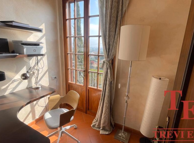 Sunny home office with scenic view and modern furniture.