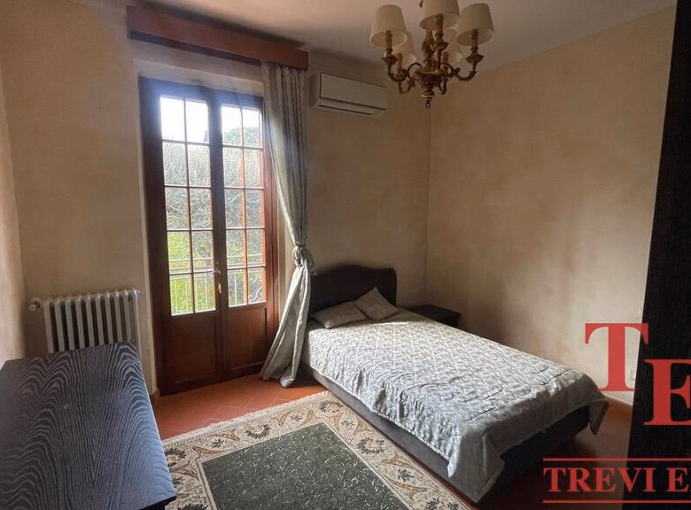 Cozy bedroom with single bed and elegant decor.