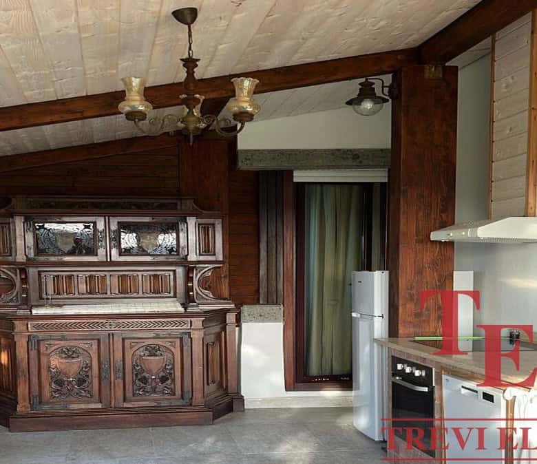 Ornate wooden antique cabinet with intricate carvings in a rustic kitchen setting.