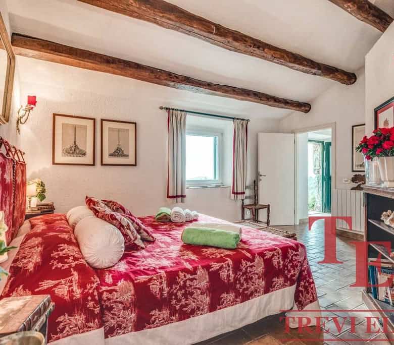 Luxurious Italian bedroom with elegant red velvet bedding, rustic wooden beams, and classic decor, perfect for a traditional Italian home.