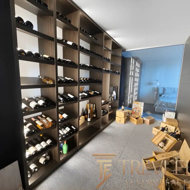 Custom wine cellar with floor-to-ceiling wooden racks and ambient lighting.