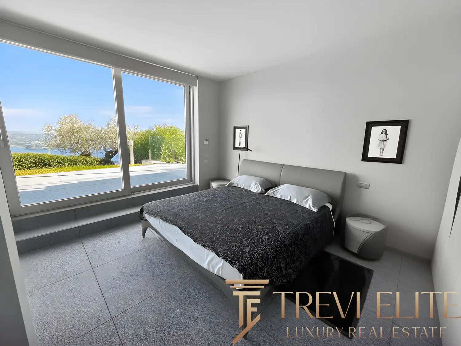 Master bedroom with a large window and minimalist black-framed accents.