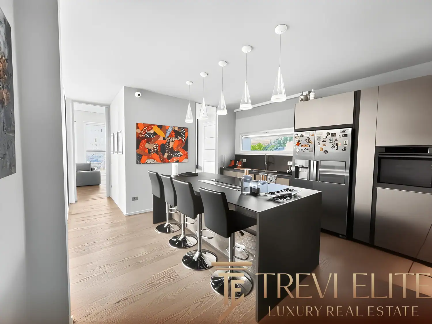 Contemporary dining room with a long table, black chairs, and lake views.