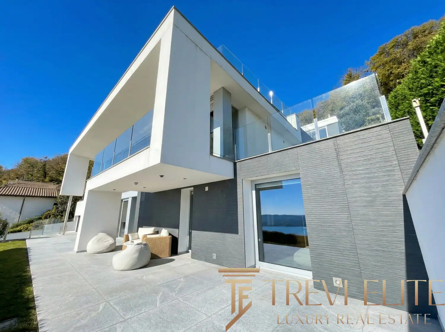 Exterior shot of the villa featuring the rooftop infinity pool and glass railings.
